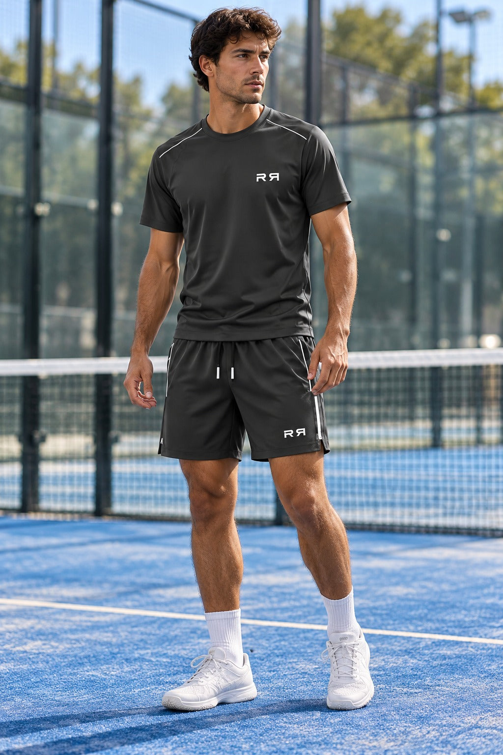 Charcoal RETRN Drop 01 Matching set front view on a padel court